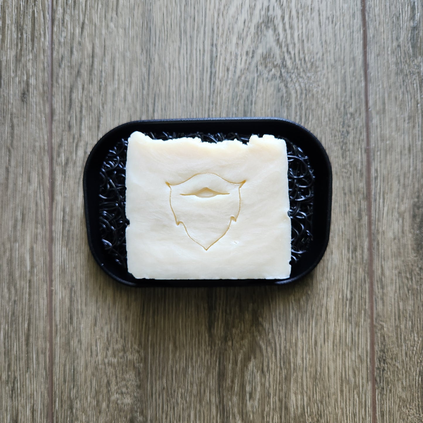 Beard bar soap on a black soap lift and waterfall dish