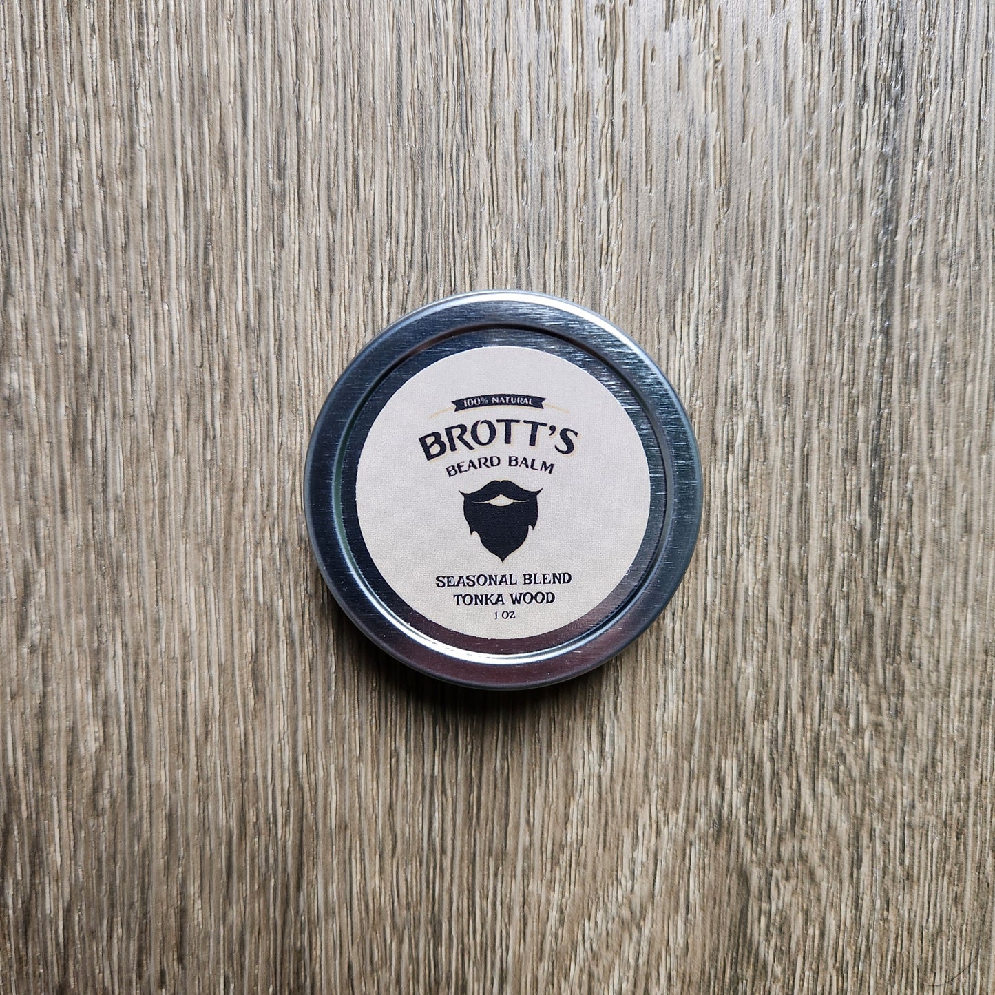 One ounce tin of beard balm with a Tonka and Wood scent.